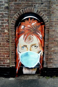 Street art head and shoulders image of Bowie (Ziggy Stardust era) wearing a blue surgical face mask
