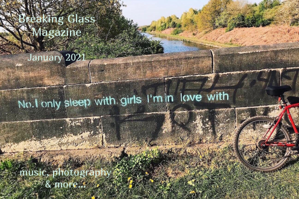 A stone bridge over a river with this slogan stencilled on in light blue paint ‘No. I only sleep with girls I’m in love with’.